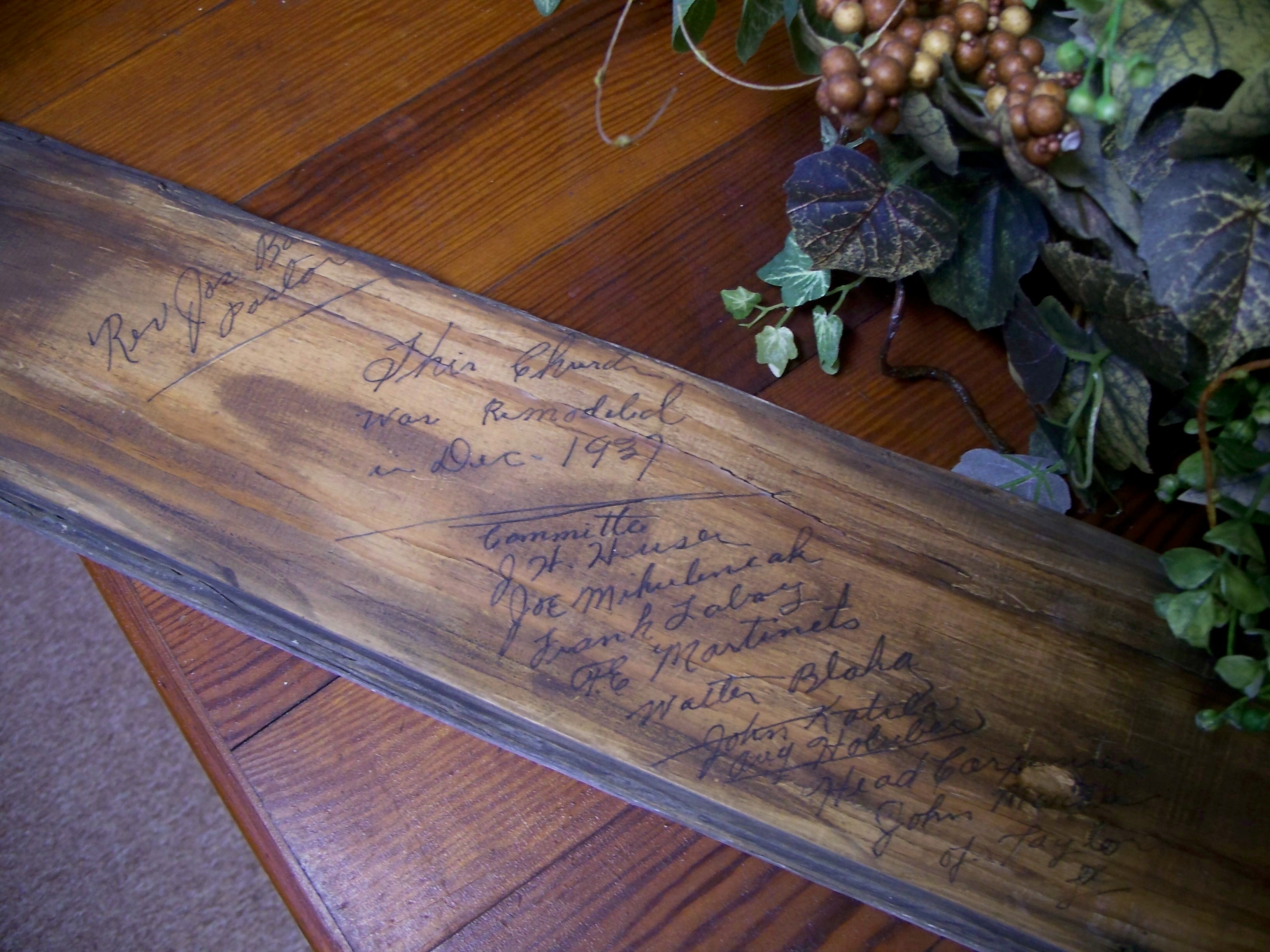Close-up of the wood plank signed by Rev. Barton and the 1937 building committee, sealed inside the bell tower.