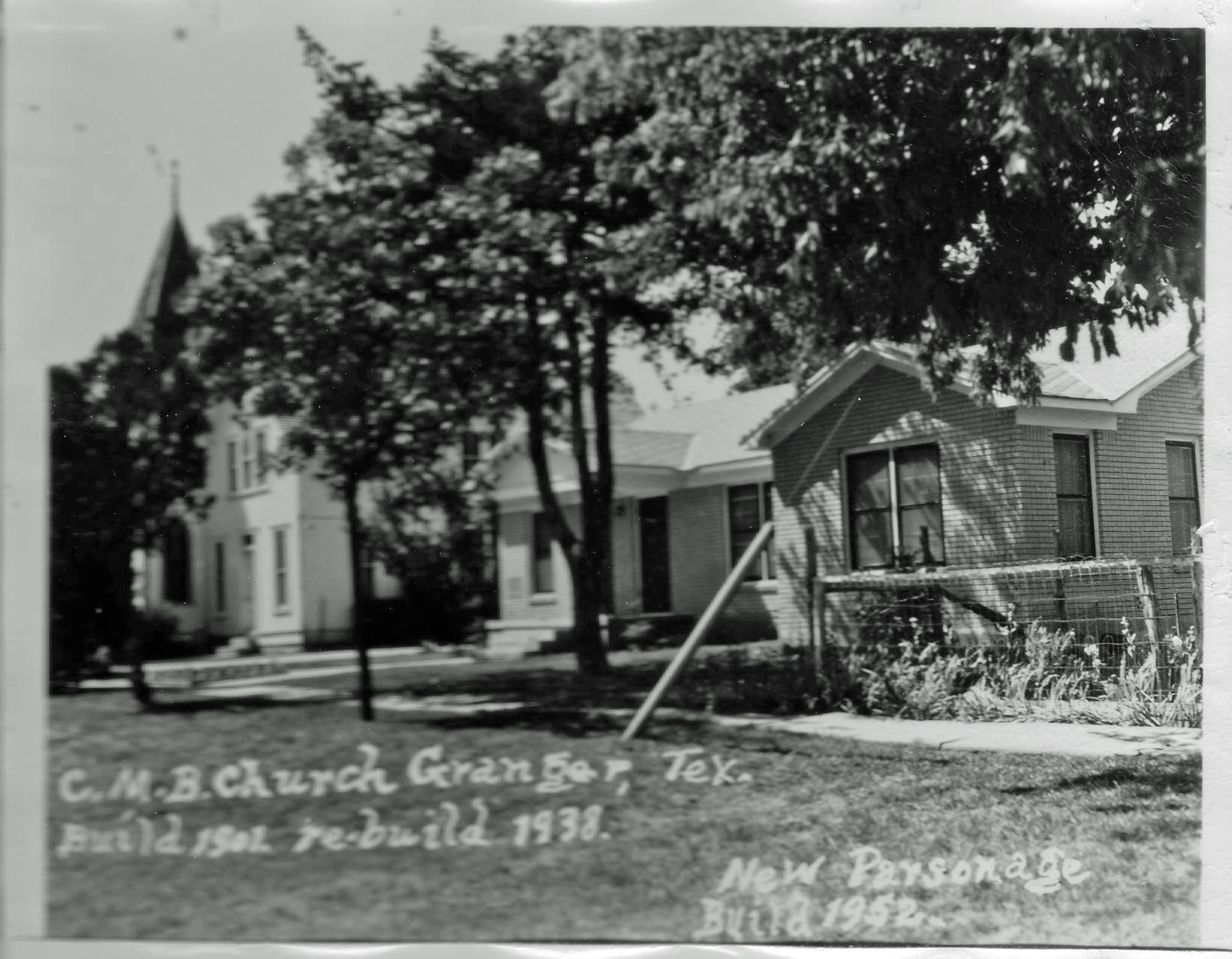 Hand-labeled black-and-white photograph showing the church alongside the newly-built parsonage in 1952.